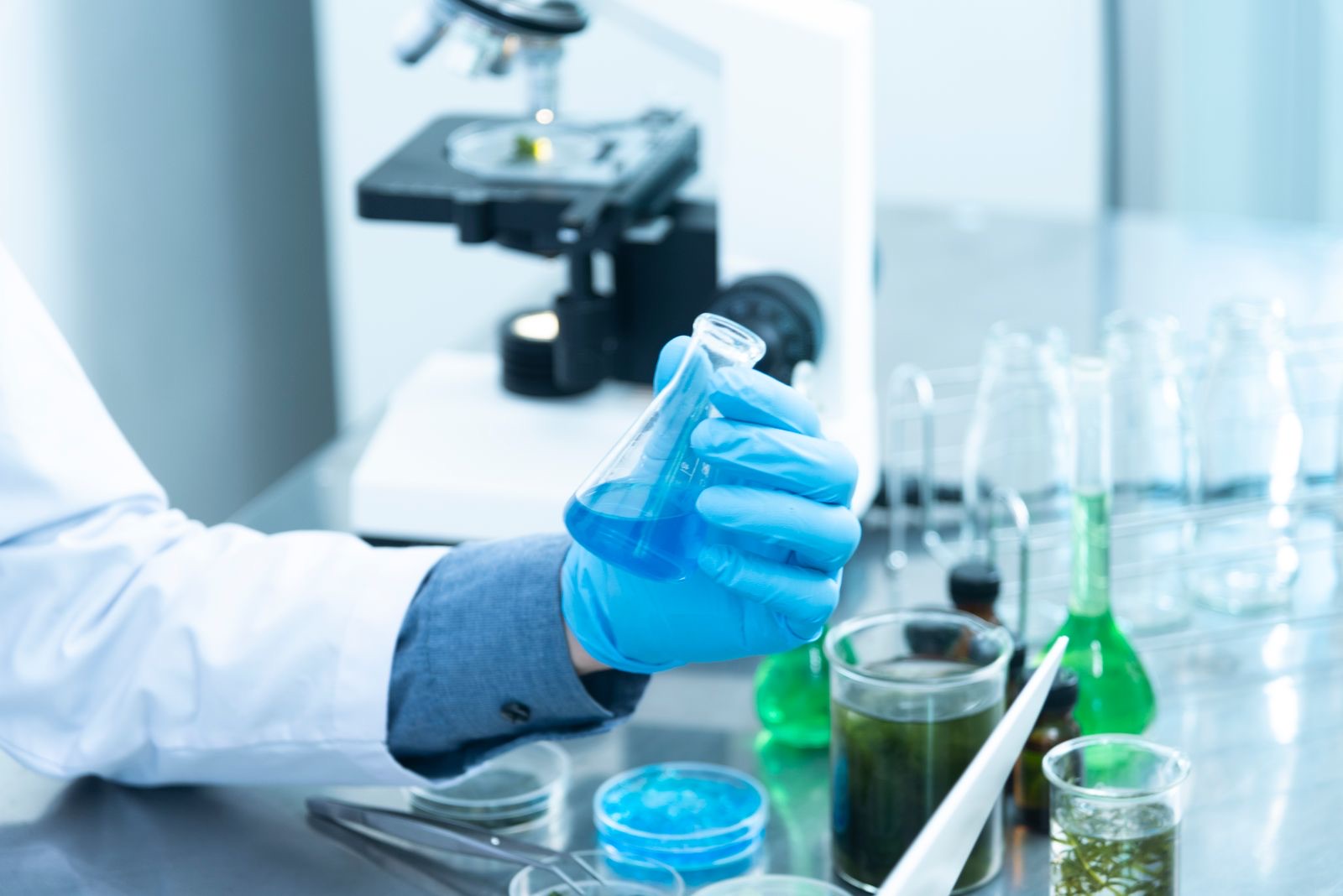 Researcher working with laboratory glassware
